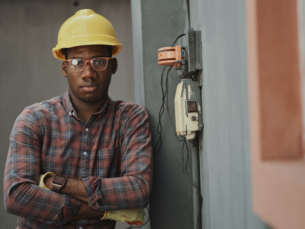 A Luxwell-approved engineer beside an electrical installation