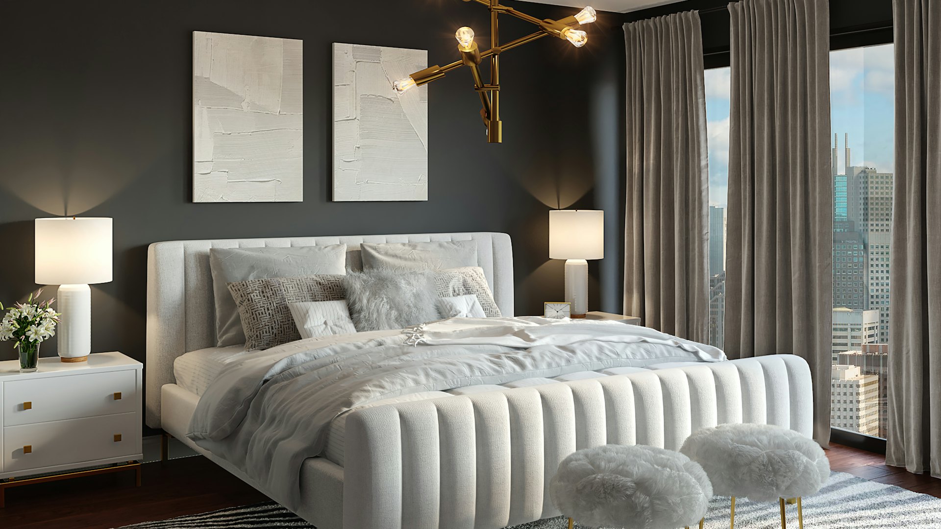 A dark, beautifully lit bedroom room set with a brass chandelier and warm bedside lamps