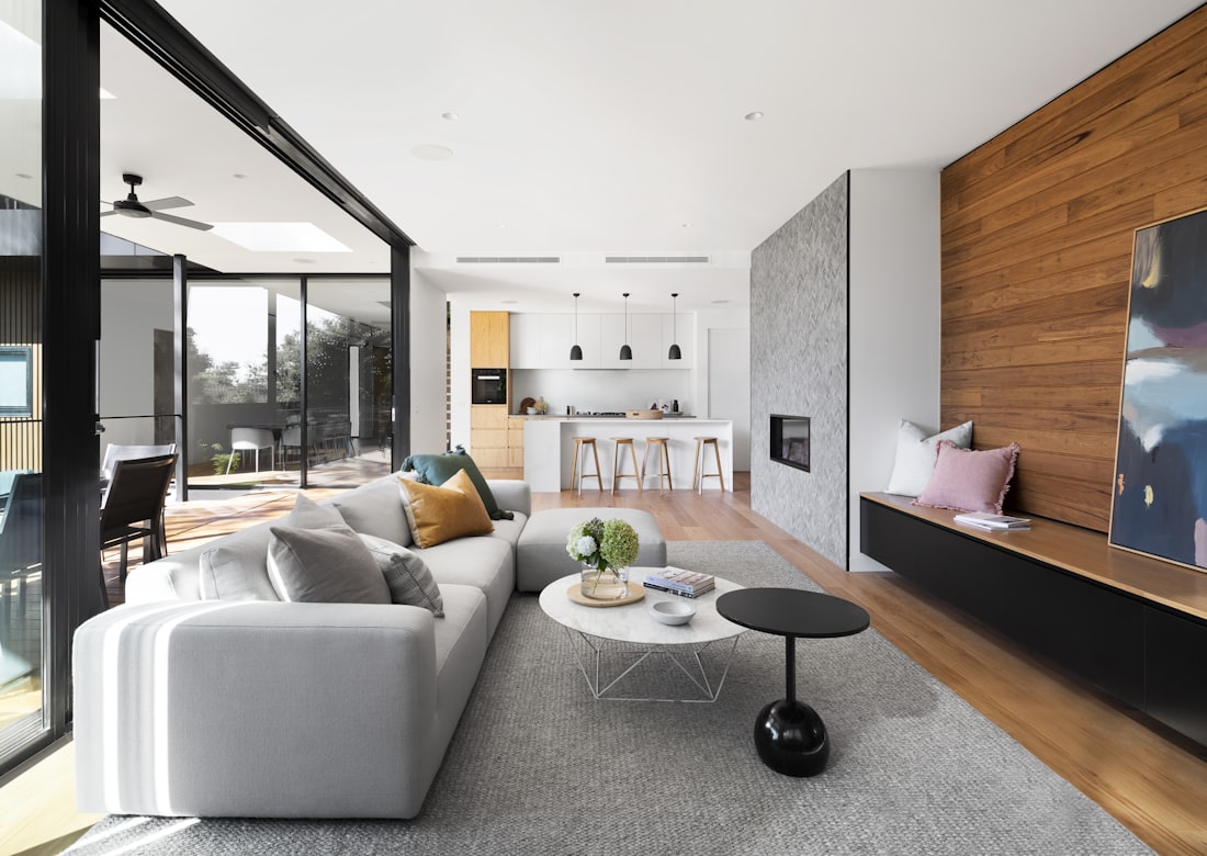 An open-plan living space in the Luxwell showroom with layered lighting